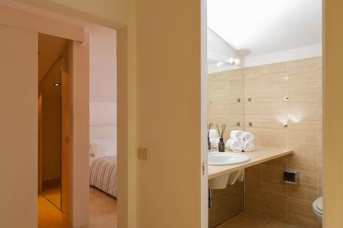 a bathroom with a sink and a bed at greve center apartments in Greve in Chianti