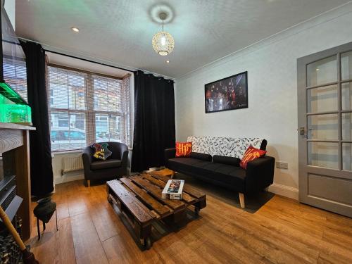 a living room with a couch and a coffee table at MAGICAL HARRY POTTER THEMED HOME IN WATFORD - FREE off-street PARKING in Watford