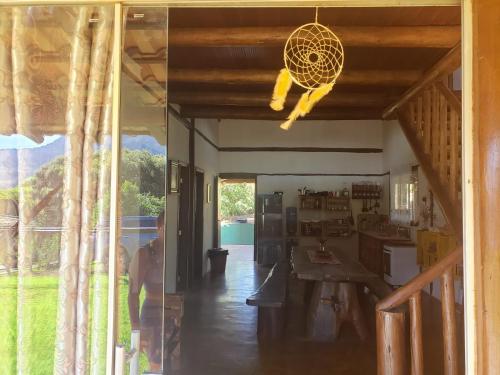 a living room with a table and a ceiling at Casa do Rogério in Santana do Riacho