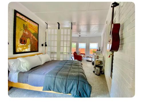 a bedroom with a bed and a guitar in it at Toadhaus Studio in quiet residential neighborhood ATHENS in Athens