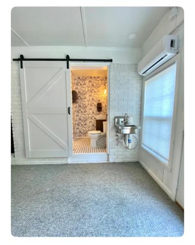 a bathroom with a door leading to a toilet at Toadhaus Studio in quiet residential neighborhood ATHENS in Athens