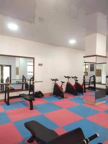 a gym with a bunch of exercise bikes in a room at Enzi heights in Nairobi