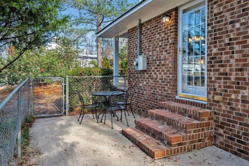 a brick house with a table and a patio at Downtown Gem, 2 Kings, 1 Queen, Newly Renovated in Apex