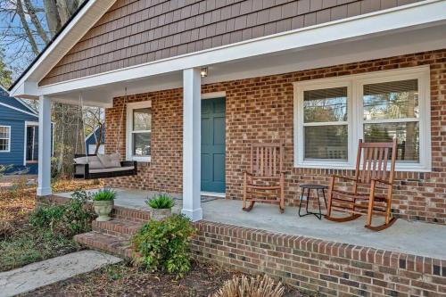 a brick house with two chairs and a table on a porch at Downtown Gem, 2 Kings, 1 Queen, Newly Renovated in Apex