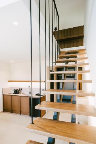 a wooden staircase in a kitchen with a sink at LAN-GO SIVOTA Luxury Living in Sivota