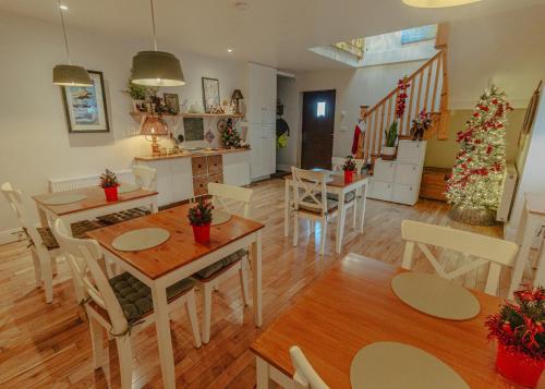 a living room with tables and chairs and a christmas tree at MOUNT BARKER in Swords