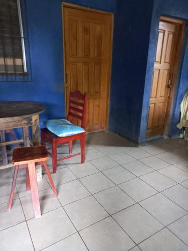 a room with two chairs and a table and a door at Cabinas Chavez in Rivas