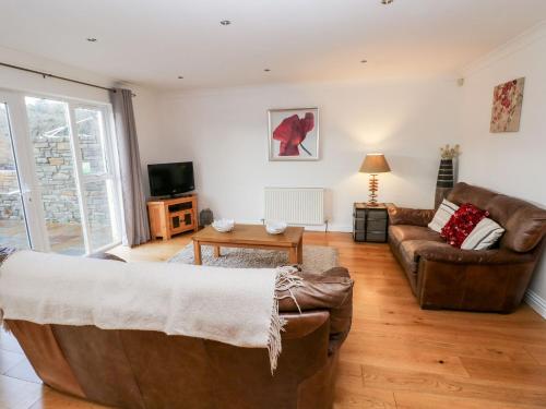 a living room with a couch and a table at Egret in Milford Haven