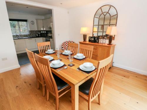 a dining room with a wooden table and chairs at Egret in Milford Haven