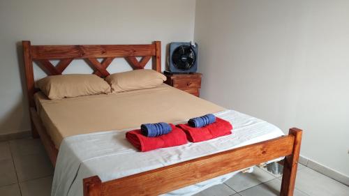 two towels sitting on a bed in a bedroom at Altos Mendoza Calle Entre Ríos in Mendoza