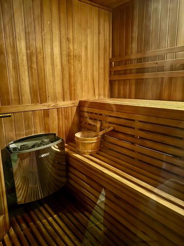 a wooden sauna with a bucket and a trash can at Agriturismo Al Mancino in Lonato del Garda
