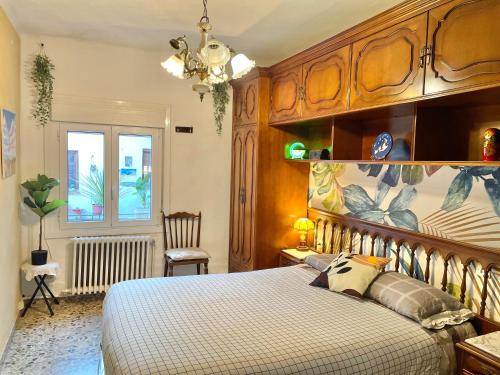 Schlafzimmer mit einem großen Bett mit einem Kopfteil aus Holz in der Unterkunft Casa Rural in Valtierra