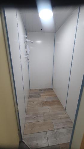 a bathroom with a shower and a tile floor at "PONY POD" at Nelson Park Riding Centre Ltd - GLAMPING POD also available the fox pod and Trailor Escapes- BIRCHINGTON, RAMSGATE, BROADSTAIRS MARGATE in Kent
