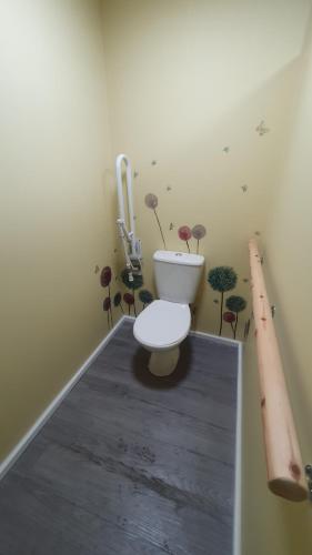 a bathroom with a toilet with plants on the wall at "PONY POD" at Nelson Park Riding Centre Ltd - GLAMPING POD also available the fox pod and Trailor Escapes- BIRCHINGTON, RAMSGATE, BROADSTAIRS MARGATE in Kent