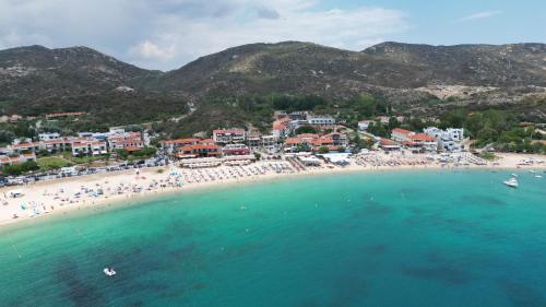 an aerial view of a beach with people in the water at House Stella Kalamitsi - Studios & Apartments in Kalamitsi