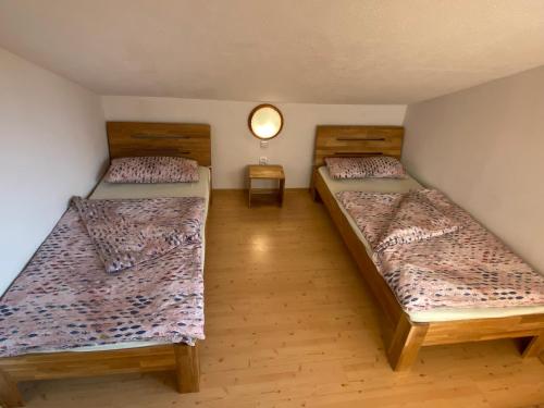 a room with two beds and a lamp at Nad Strumykiem APARTAMENT in Ochotnica Dolna