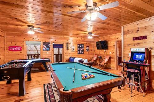 a billiard room with a pool table in a cabin at A Moment Inn Time in Pigeon Forge