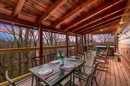 a wooden deck with a table and chairs on it at A Moment Inn Time in Pigeon Forge