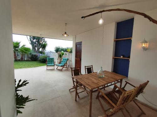 a dining room with a wooden table and chairs at Cuore di Ognina - Appartamenti vista mare in Ognina