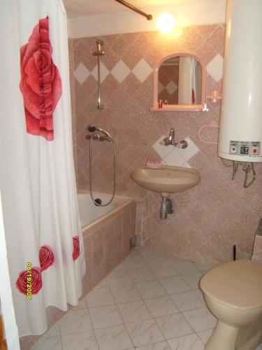 a bathroom with a toilet and a sink and a shower at Villa Trakia in Golden Sands