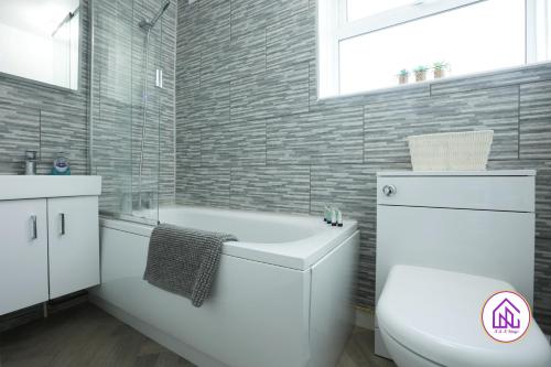 a bathroom with a white toilet and a bath tub at Highfield House, Great Location, Free Parking in Bath