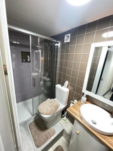 a bathroom with a shower and a toilet and a sink at Airstaybnb in Manchester