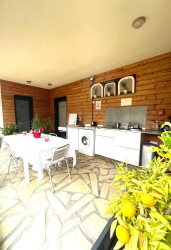 a kitchen with a white table and chairs and a counter at L'étape Provencale in Cabriès