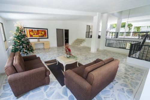 a living room with two couches and a christmas tree at Babilla Suites in Cali