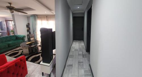 a living room with a couch and a flat screen tv at Jo's Eden in Edenvale