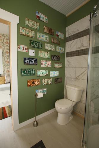 a bathroom with a toilet and signs on the wall at The Fishmongers Dream in York