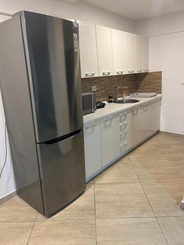 a large stainless steel refrigerator in a kitchen at Resort Stikovic in Dobra Voda
