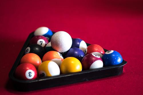 a tray of billiard balls on a red table at Apartamenty Gorczańskie in Rabka