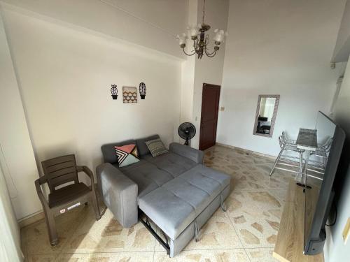 a bedroom with a bed and a chair and a television at Apartamento en Venecia con parqueadero cubierto in Sincelejo