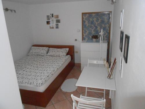 a bedroom with a bed and a table with chairs at Love 2 Solkan in Nova Gorica