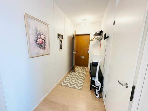 a hallway with a room with a treadmill in it at Relax Convenient Transit Stays -shared apartment in Vantaa