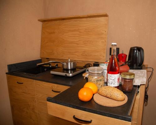 a kitchen counter with fruit and bottles of wine at Casa Zefìra in Feltre