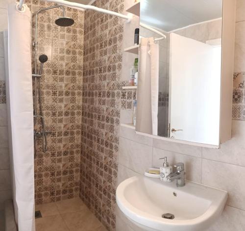 a bathroom with a sink and a shower at Blue View-Μπλε Θέα in Aigáni