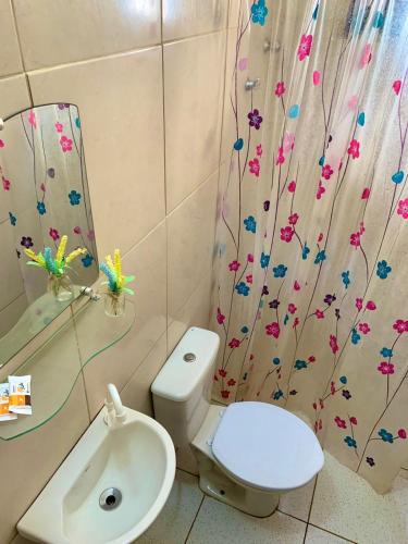 a bathroom with a toilet and a sink at Chalé Estrela do mar 2 in Galinhos