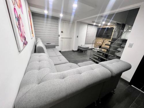 a living room with a large couch and chairs at Casa vacacional en Pereira in Pereira