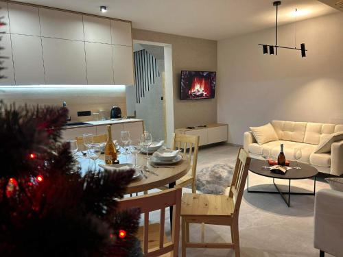 a living room with a christmas tree and a dining table at Hreśkowa Osada - Domki w Górach in Szaflary