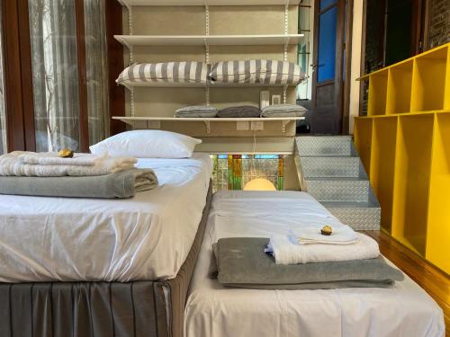 two beds with towels on them in a room at Casa Almendra in Rosario
