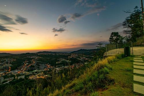 a view of a city from a hill at sunset at Apartamento Aconchegante Centro Serra Negra in Serra Negra