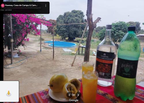 Jayanca的住宿－Kawsay, Casa de Campo & Camping，一瓶饮料和一些水果放在桌子上