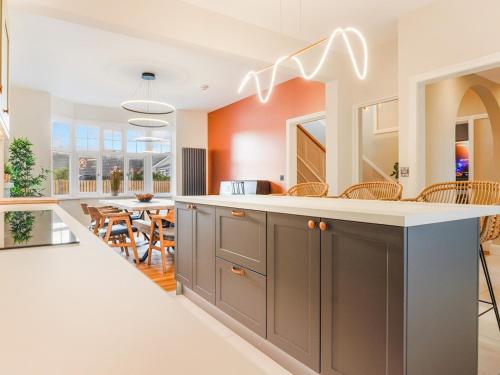 an open kitchen with an island and a dining room at Pass the Keys Breathtaking holiday home packed with amenities in Borth