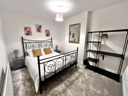 a bedroom with a black and white bed and a shelf at Modern Mountain Retreat in the Brecon Beacons in Ystradgynlais