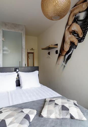a bedroom with a bed with a poster on the wall at Boutique Hotel View in Amsterdam