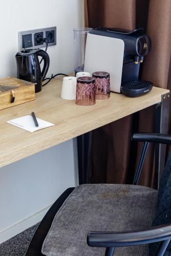 a desk with a coffee machine on top of it at Boutique Hotel View in Amsterdam