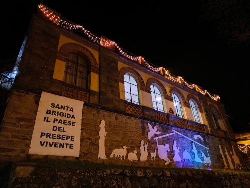 a building covered in christmas lights with a sign on it at La Casa di LiLi in Pontassieve