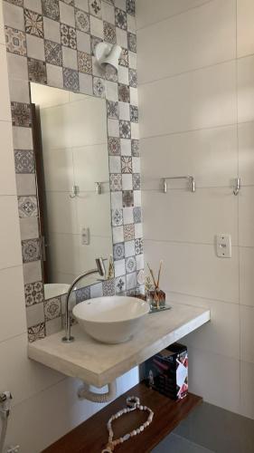 a bathroom with a sink and a mirror at Milagres de Minas in São Miguel dos Milagres