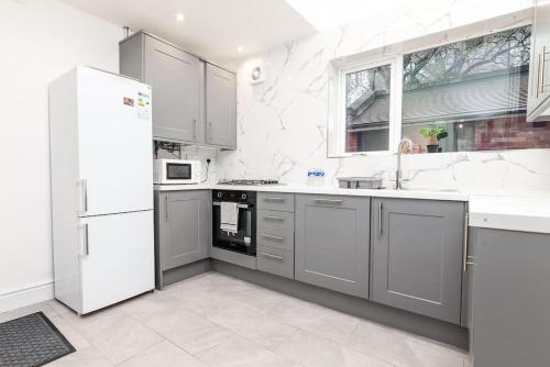 a kitchen with white appliances and a white refrigerator at Holiday Lodge, close to Nottingham City Centre in Nottingham